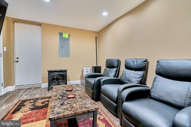 cinema room with electric panel and hardwood / wood-style floors