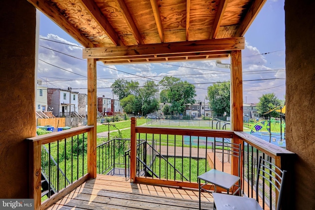 wooden deck with a lawn