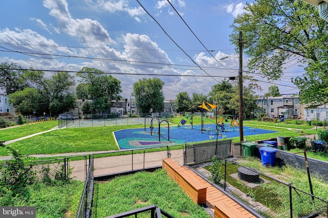 view of property's community with a lawn and a playground