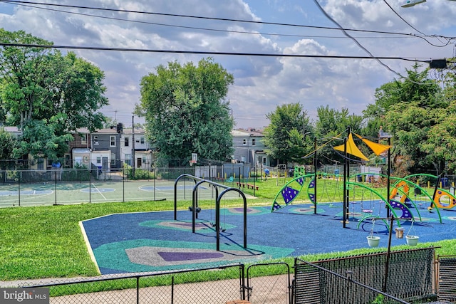 view of jungle gym with basketball hoop and a lawn