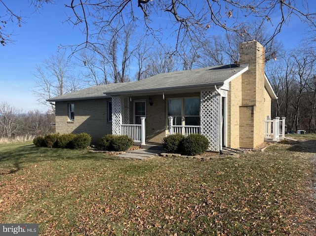 single story home with a porch and a front lawn