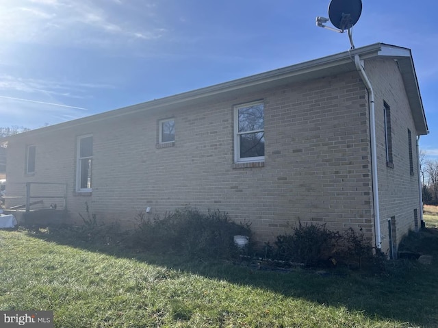 view of property exterior with a lawn