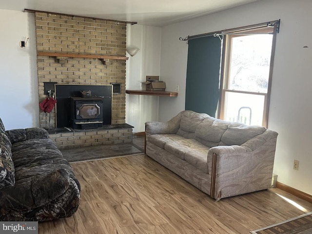 living room with hardwood / wood-style flooring and a wood stove