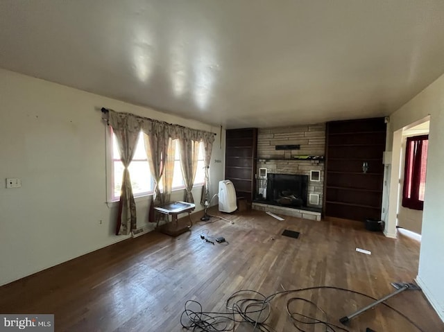 unfurnished living room with a fireplace and hardwood / wood-style floors