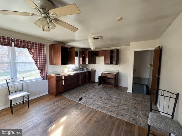 kitchen featuring dark hardwood / wood-style floors, ceiling fan, and a wealth of natural light