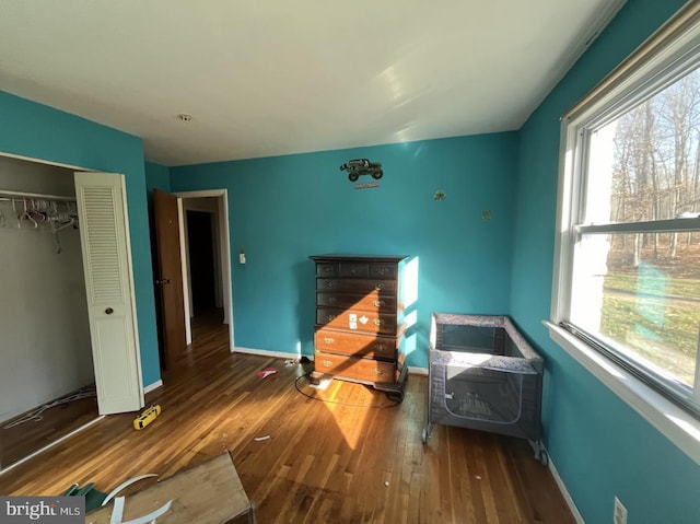 unfurnished bedroom featuring a closet and hardwood / wood-style floors