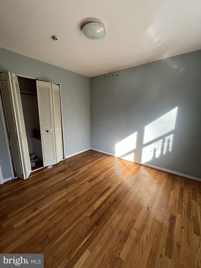 unfurnished bedroom with hardwood / wood-style floors