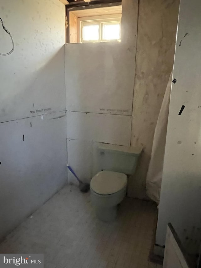 bathroom featuring hardwood / wood-style flooring and toilet