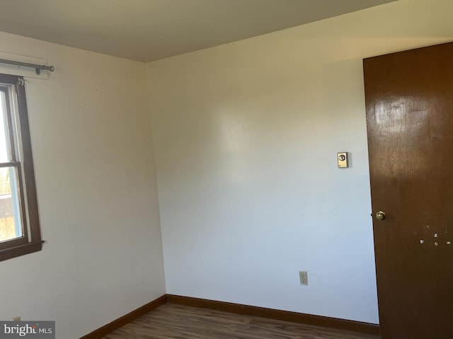 unfurnished room with dark hardwood / wood-style flooring