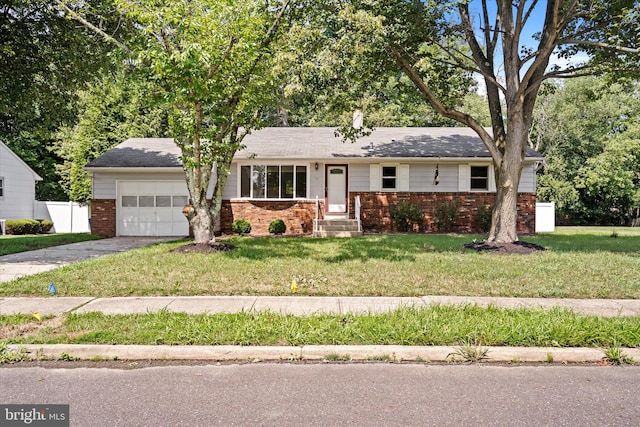 ranch-style home featuring a front yard and a garage