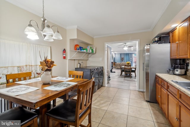 dining area featuring light wood-type flooring, ornamental molding, and ceiling fan with notable chandelier