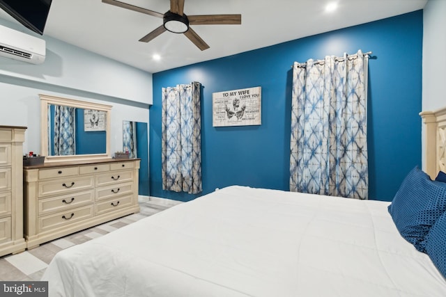 bedroom featuring ceiling fan, a wall unit AC, and light hardwood / wood-style floors