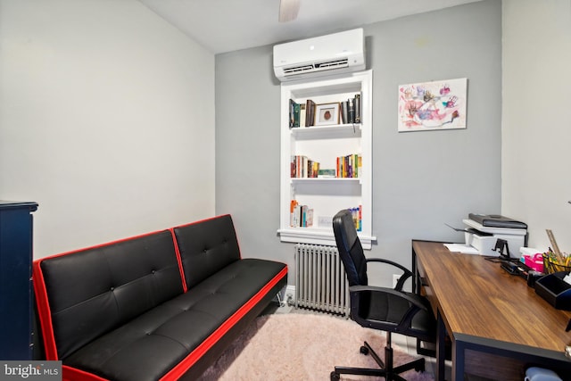 office area with radiator heating unit, a wall mounted air conditioner, carpet flooring, and built in shelves