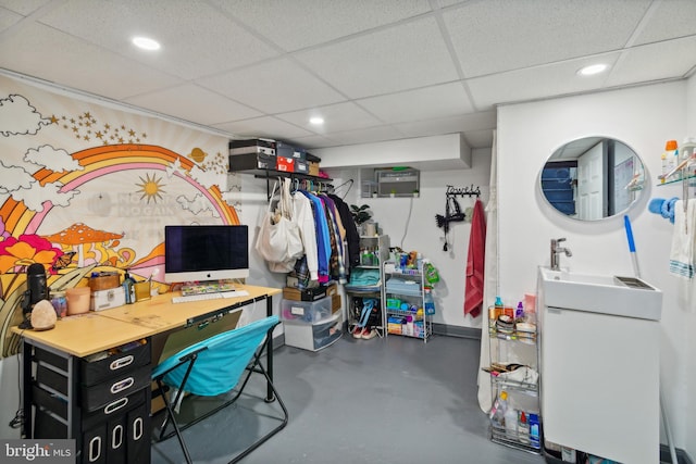 interior space featuring a drop ceiling and concrete flooring