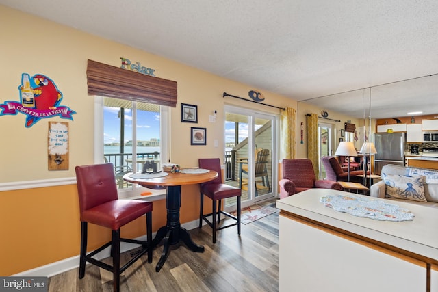 500 32nd St Unit A, Ocean City, MD 21842 - dining space with wood finished floors, plenty of natural light, baseboards, and a textured ceiling