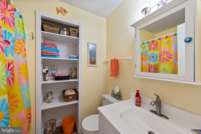 500 32nd St Unit A, Ocean City, MD 21842 - bathroom featuring toilet, vanity, and curtained shower