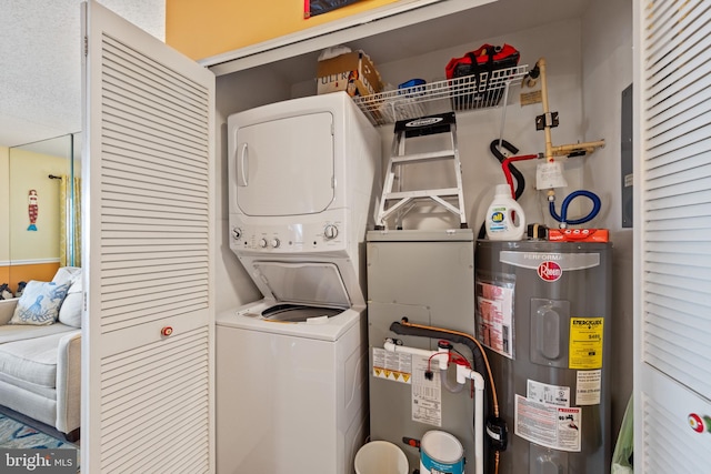 500 32nd St Unit A, Ocean City, MD 21842 - laundry room featuring stacked washer / drying machine and electric water heater