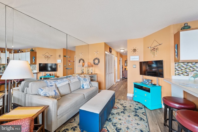 500 32nd St Unit A, Ocean City, MD 21842 - living area featuring light wood-style flooring and a textured ceiling