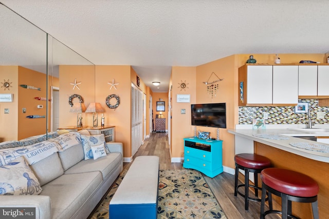 500 32nd St Unit A, Ocean City, MD 21842 - living room with wood finished floors, a textured ceiling, and baseboards