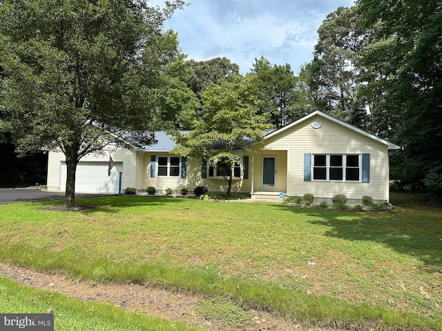 ranch-style house with a garage and a front lawn