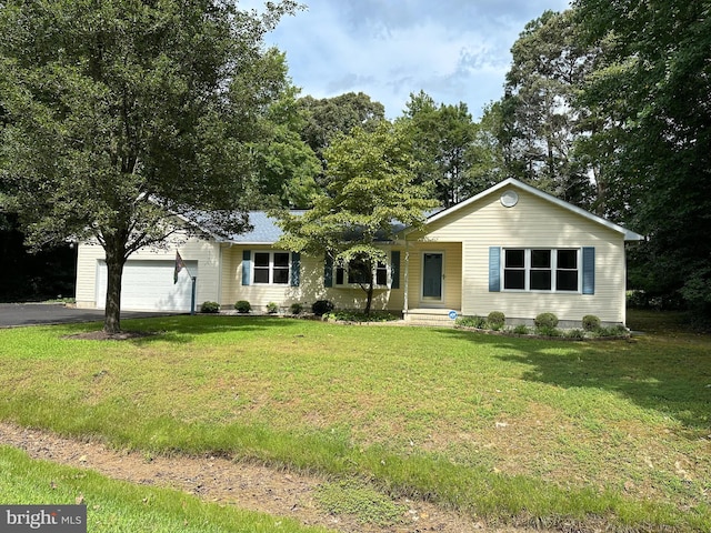 single story home featuring driveway, an attached garage, and a front yard