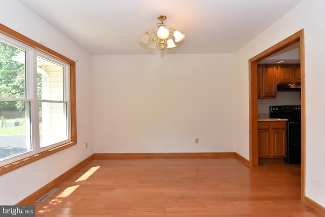 interior space with light wood-type flooring and a notable chandelier