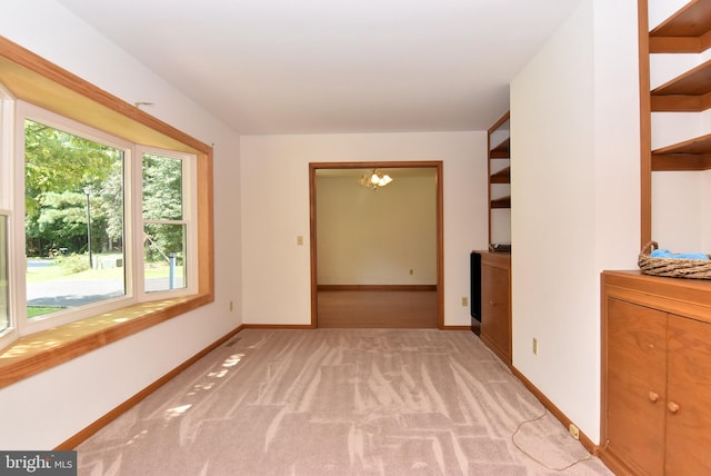 unfurnished room featuring light colored carpet