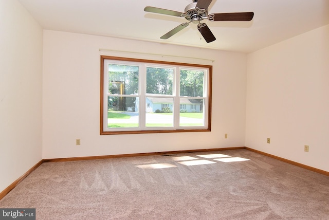 unfurnished room with carpet floors and ceiling fan