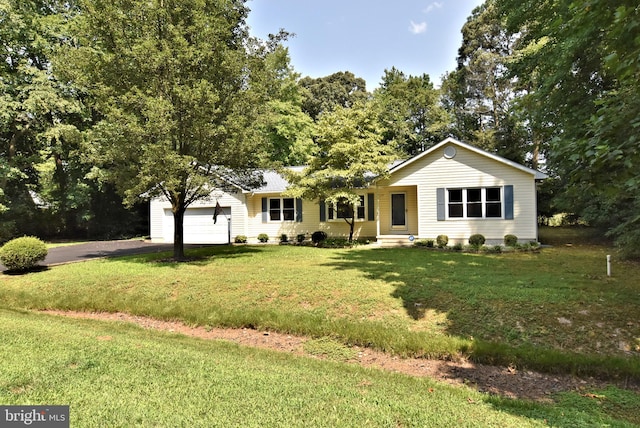 ranch-style home featuring a garage and a front lawn