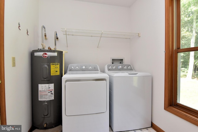 washroom featuring water heater and independent washer and dryer