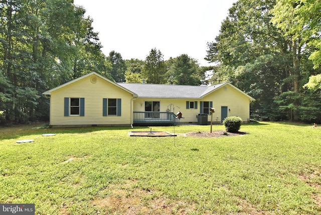 rear view of house featuring crawl space, a lawn, and a wooden deck