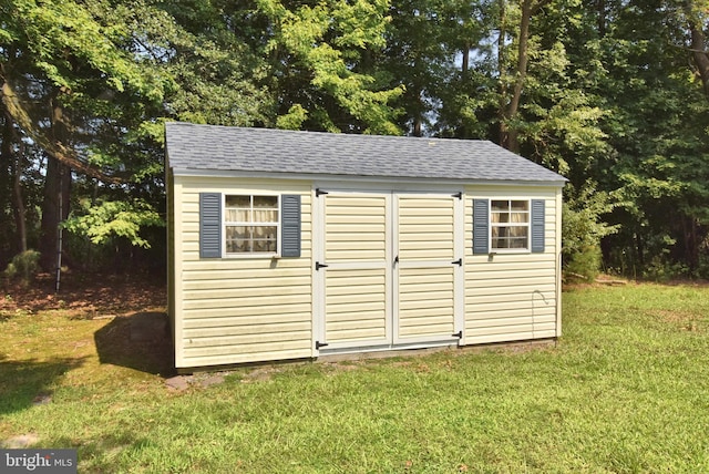 view of outbuilding featuring a yard