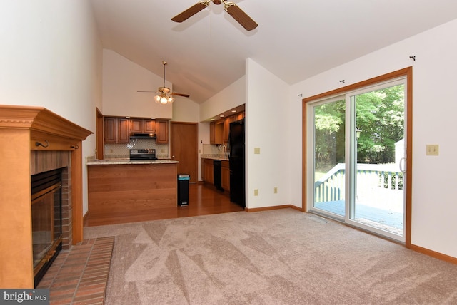 interior space featuring high vaulted ceiling, sink, a brick fireplace, carpet floors, and ceiling fan