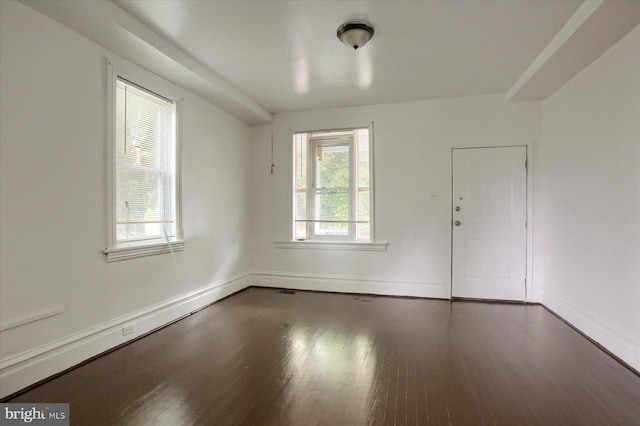 unfurnished room with dark hardwood / wood-style floors