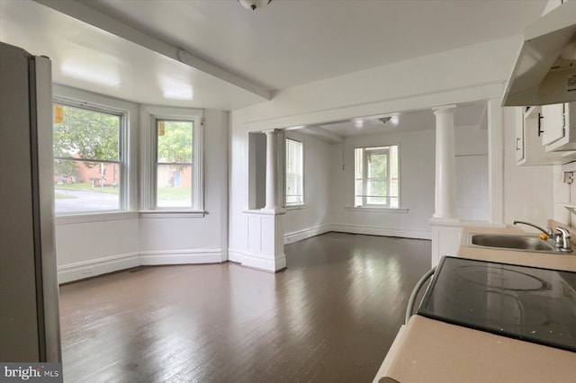 kitchen featuring sink, white cabinetry, dark hardwood / wood-style flooring, decorative columns, and exhaust hood