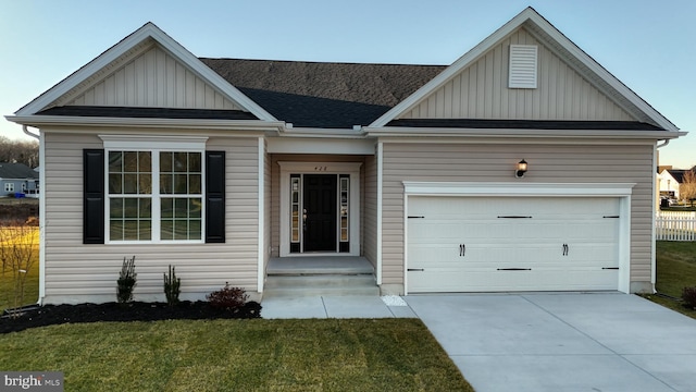 view of front of home with a garage and a front lawn