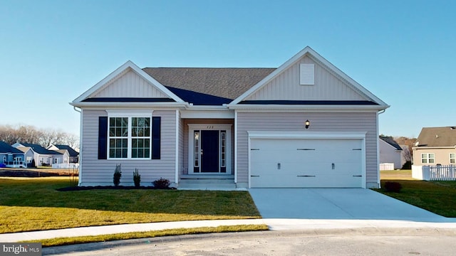 view of front of property featuring a garage and a front yard