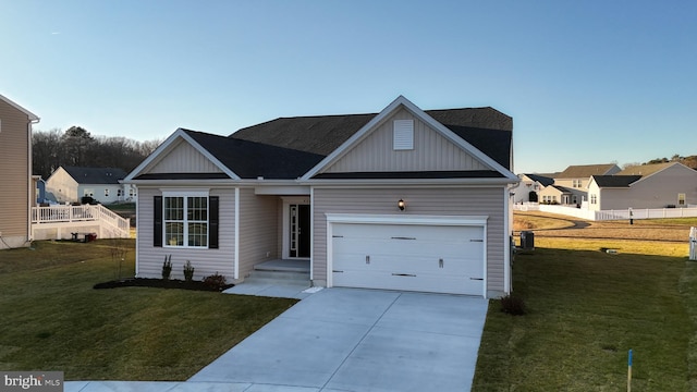 view of front of home featuring a front yard and a garage