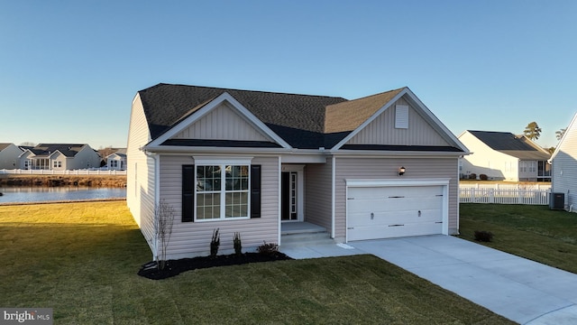 view of front of home featuring a front yard, a water view, a garage, and central air condition unit