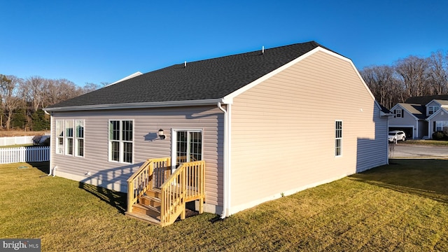 rear view of house featuring a yard