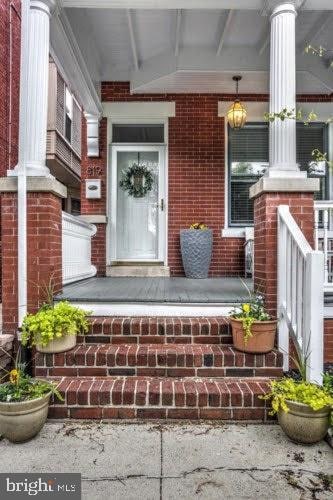 property entrance with a porch and a garage