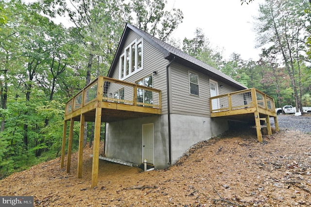 view of side of home with a wooden deck