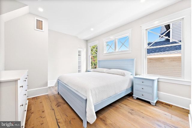 bedroom with recessed lighting, baseboards, visible vents, and light wood finished floors