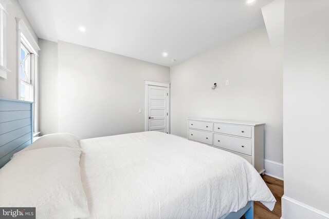 bedroom with hardwood / wood-style flooring