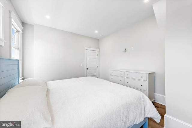 bedroom featuring baseboards, dark wood-type flooring, and recessed lighting