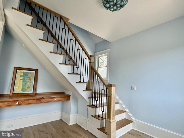 staircase featuring hardwood / wood-style flooring