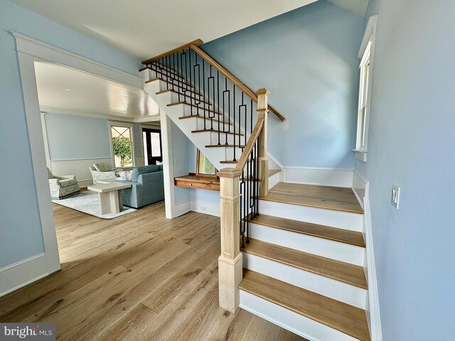 staircase with hardwood / wood-style flooring