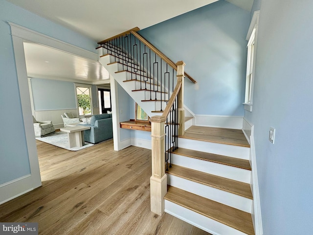 stairway featuring wood finished floors and baseboards