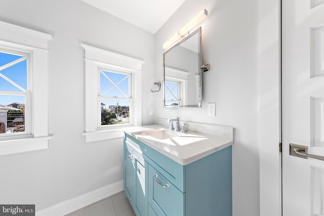 bathroom featuring tile patterned flooring, baseboards, and vanity