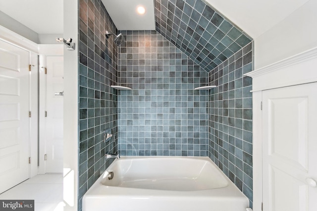 bathroom with tile patterned floors and tiled shower / bath